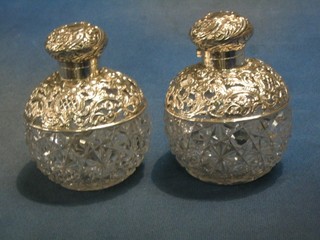 A handsome pair of Victorian globular cut glass scent bottles with stoppers and pierced silver mounts, Birmingham 1898