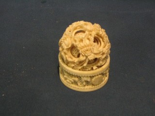 A pierced and carved ivory napkin ring and an ivory puzzle ball 2"