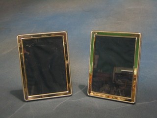 A pair of modern plain silver easel photograph frames with bead work borders 6" x 5"