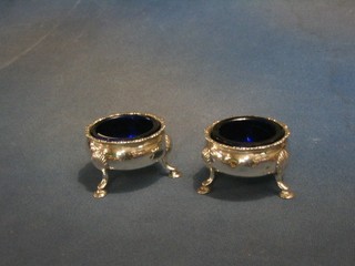 A pair of George III circular silver salts with cast borders and blue glass liners, raised on 3 hoof feet, London 1763 4 ozs
