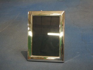 A modern plain silver easel photograph frame 6" x 5"