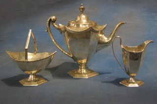 A silver 3 piece octagonal shape tea service  with teapot, a boat shaped sugar bowl with swing handle and a cream jug Sheffield 1910 by Walker & Hall 43ozs