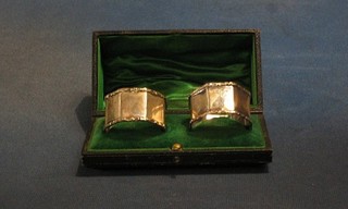 A pair of octagonal silver napkin rings with cast borders Sheffield 1912, cased 2 ozs