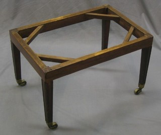 A Georgian mahogany rectangular stool, raised on square tapering supports ending in brass caps and castors 26"