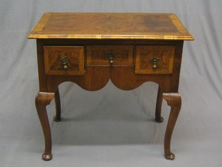 A 19th Century figured walnut low boy with crossbanded top, fitted 1 long and 2 short drawers, raised on cabriole supports (damage to left hand crossband on top and with later restoration) 32"