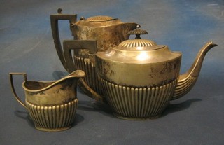 A 4 piece silver plated tea service comprising tea pot, hotwater jug, twin handled sugar bowl and cream jug with demi-reeded decoration
