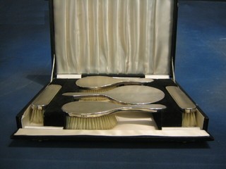A 6 piece silver backed dressing table set comprising 2 clothes brushes, 2 hair brushes, hand mirror and comb, London 1972