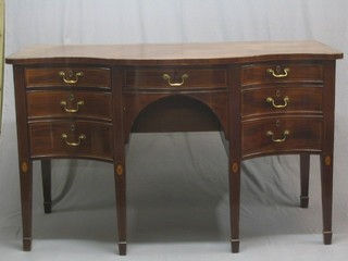 A handsome Georgian Irish mahogany sideboard of serpentine outline, fitted a drawer flanked by 2 short and 2 long drawers 1 fitted a cellarette and with pot cupboard to the side, raised on square supports ending in spade feet 68"