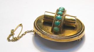 A circular gilt metal brooch set turquoise