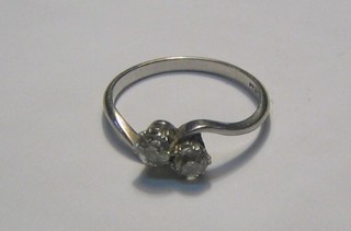 A lady's 18ct gold cross-over dress ring set 2 diamonds 