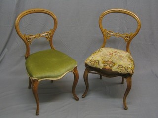 A pair of Victorian bleached walnut balloon back dining chairs with pierced mid rails, the Berlin tapestry upholstered seats of serpentine outline, raised on French cabriole supports