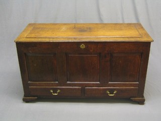 An 18th Century oak mule chest with hinged lid, the interior fitted a candle box, the base fitted 2 long drawers, raised on bracket feet 50"