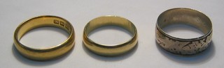 A 22ct gold wedding band, a 18ct gold wedding band and 1 other band