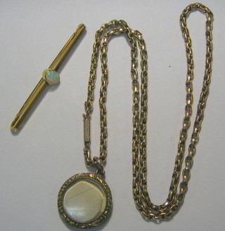 A gilt metal bar brooch, a gilt metal box link chain and a gilt metal locket