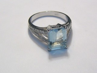 A lady's 18ct white gold dress ring set a square cut aquamarine the shoulders set numerous diamonds (approx 0.35/2.8ct)