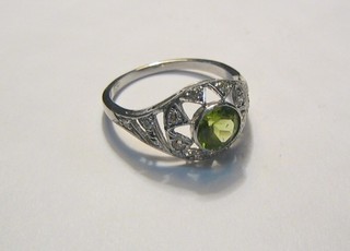 A lady's 18ct white gold dress ring set a circular cut peridot supported by diamonds