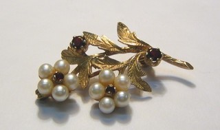 A 9ct gold brooch set pearls and garnets