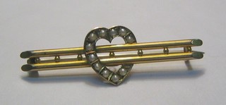 An Edwardian 9ct gold bar brooch with heart to the centre and demi-pearls