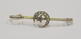 A gold bar brooch set a crescent moon and stars set garnets and demi-pearls