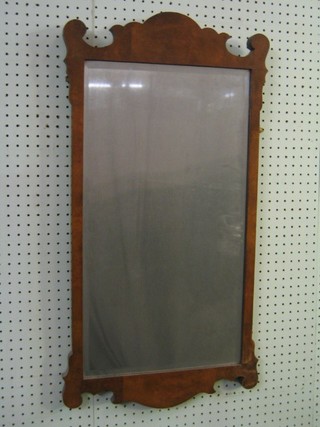 A 19th/20th Century rectangular bevelled plate Chippendale style mirror, contained in a figured walnut frame 32"
