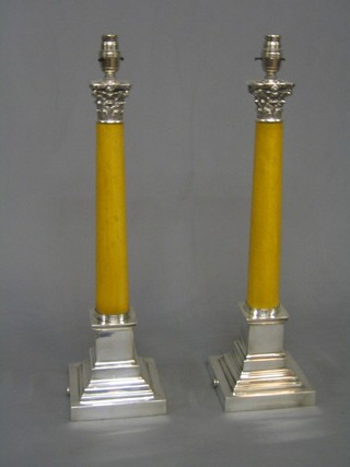 A pair of modern silver plated and marble finished table lamps in the form of Corinthian columns