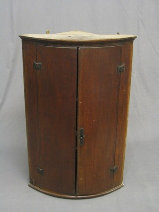An 18th/19th Century oak hanging corner cabinet with iron butterfly hinges 24"