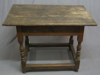 A 17th/18th Century oak side table fitted a drawer, raised on turned and block supports united by a box framed stretcher 38" (possibly later top)