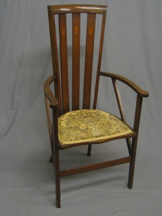 An Edwardian Art Nouveau inlaid mahogany stick and rail back carver chair