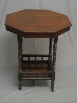An Edwardian octagonal occasional table raised on turned supports with undertier