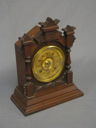 A Victorian American 8 day striking bracket clock with gilt metal dial and Arabic numerals contained in carved oak case by Ansonia 