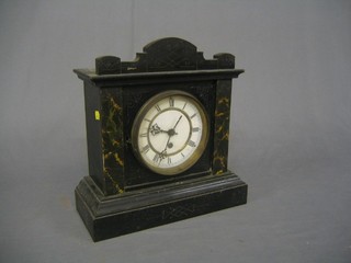 A Continental 8 day mantel clock with enamelled dial and Roman numerals contained in a carved pine case