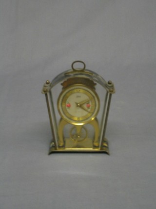 A 1950's German 8 day mantel clock with visible escapement contained in an arched case