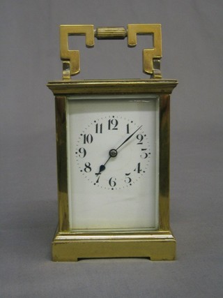 A 19th Century French 8 day striking carriage clock with 2 1/2" enamelled dial striking on a gong, contained in a gilt metal case