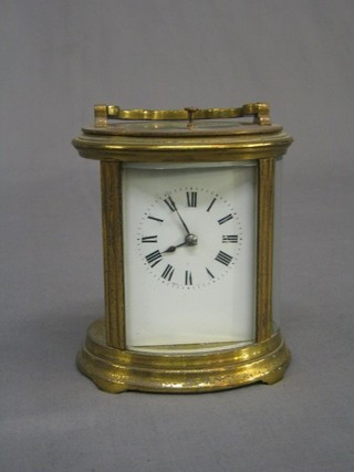 A 19th Century French 8 day striking repeating carriage clock with 2 1/2" enamelled dial with Roman numerals contained in an oval gilt metal case (case requires re-gilding and some attention)