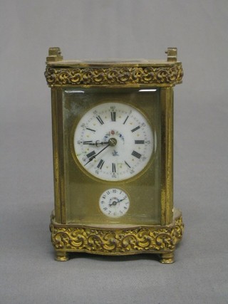 A 19th Century French 8 day carriage alarm clock, the 2" circular enamelled and floral patterned dial and alarm dial contained in a gilt metal case 3" (handle top top missing and requires some attention)