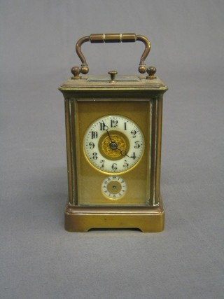 A 19th Century French 8 day repeating carriage alarm clock with circular enamelled dial and Arabic numerals, alarm dial contained in a gilt metal case, the back plate signed Revied? and numbered 7152 
