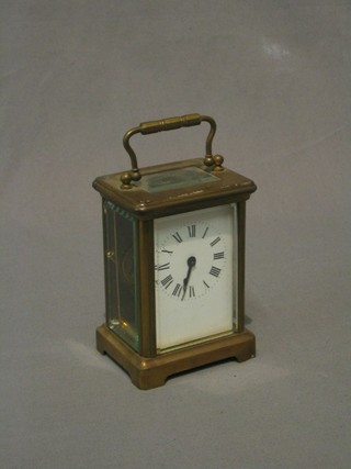 A 19th Century French 8 day carriage clock with enamelled dial contained in a gilt metal case