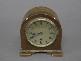 A 1930's car clock? with 4 1/2" circular silvered dial and Roman numerals by RA Halford & Sons Ltd of 41 Palmall London, contained in an arch shaped walnut case