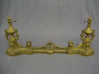 A French brass fire curb surmounted by urns 34"