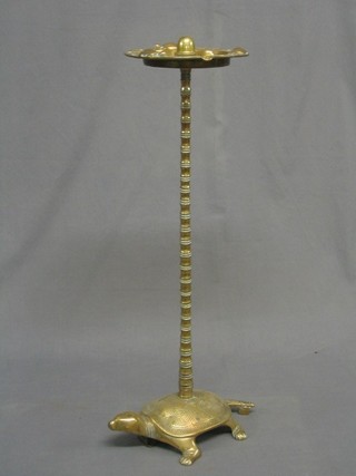 A 1930's brass smoker's pedestal ashtray supported by a turtle