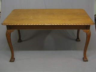A Chippendale style rectangular mahogany library table with gadrooned border, raised on cabriole ball and claw supports 60"