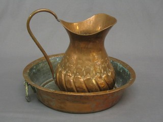 A 20th Century Eastern embossed copper jug 10" and a circular Eastern copper bowl 13"