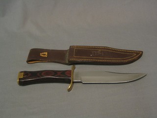 A Spanish reproduction Bowie knife with 7" blade, rosewood and brass mounted grip by Muela Albar complete with leather scabbard 