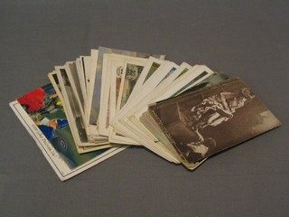 A collection of various black and white story postcards and other postcards including Royalty, military scenes etc