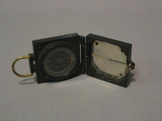 A Mark I prasmatic compass contained in a black plastic case