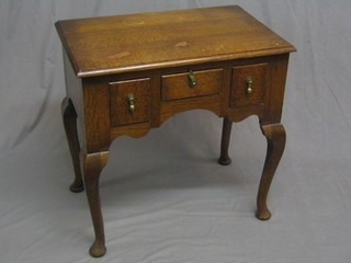 A 1930's oak low boy, fitted 1 long and 2 short drawers, raised on cabriole supports 28"