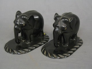 A pair of ebony book ends in the form of elephants 8"