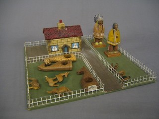A metal framed farmyard set, 2 wooden figures of Red Indians and various wooden animals