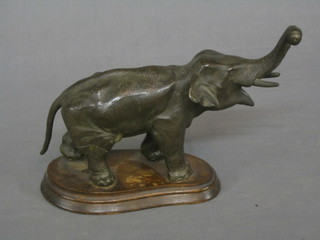 A spelter Mystery clock base in the form of a standing elephant with raised trunk 8"