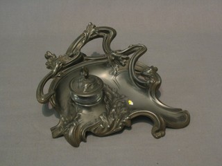 An Art Nouveau metal ink stand, the base marked Depose 101 with associated cut glass inkwell and cover 9"